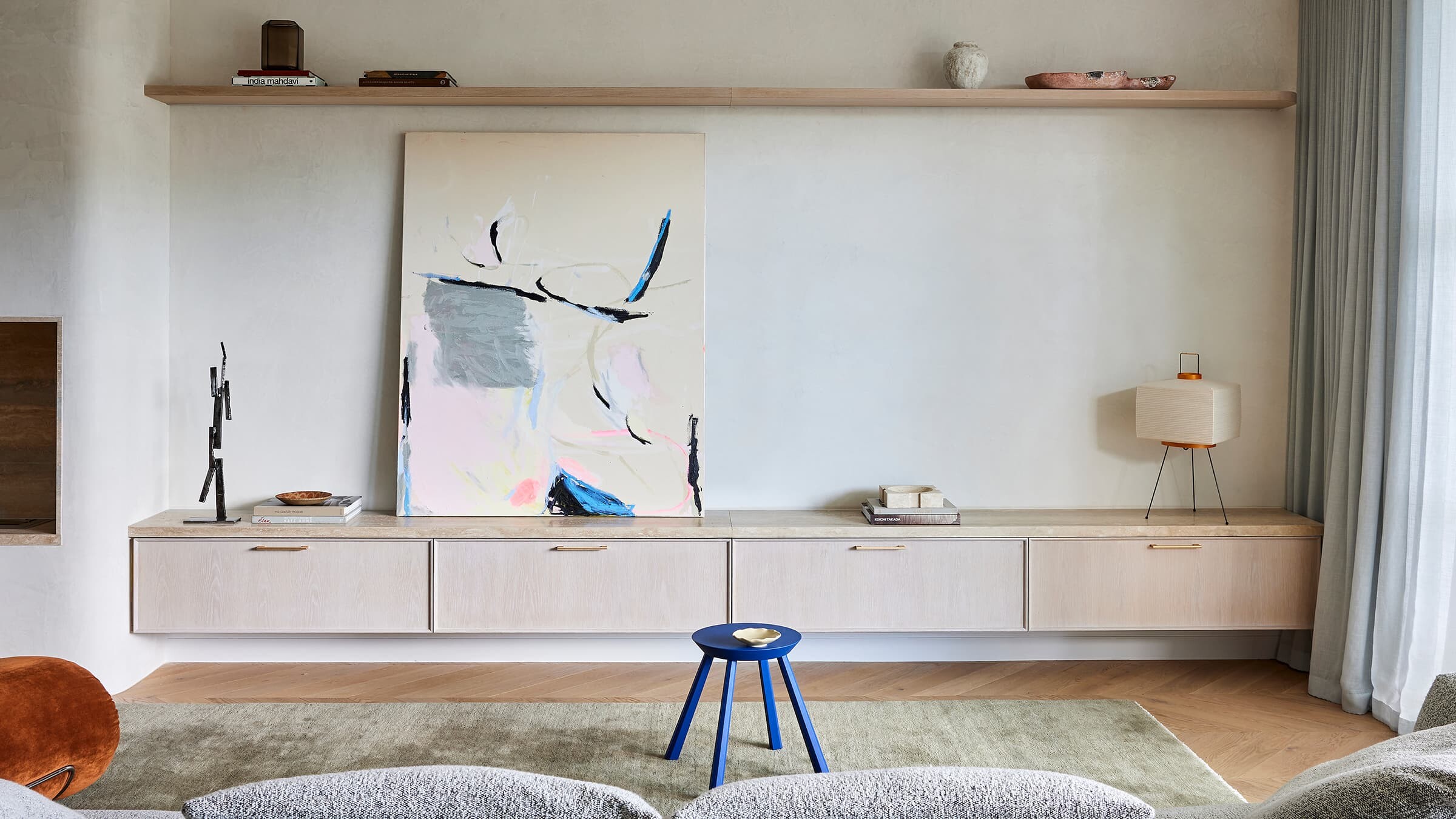 View of a wall with painting and furnished with cabinets