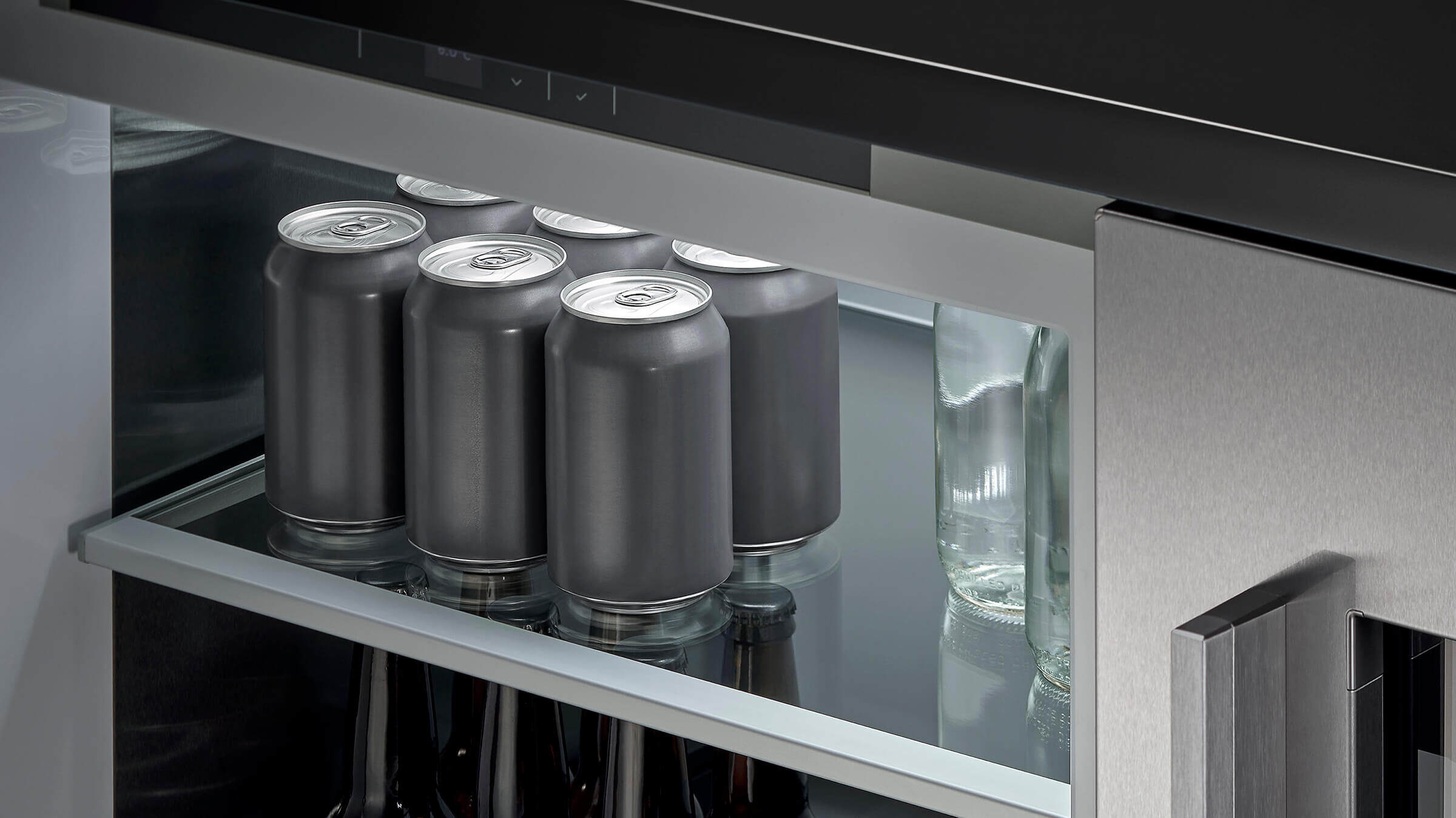Cans in an undercounter refrigerator, ready to serve