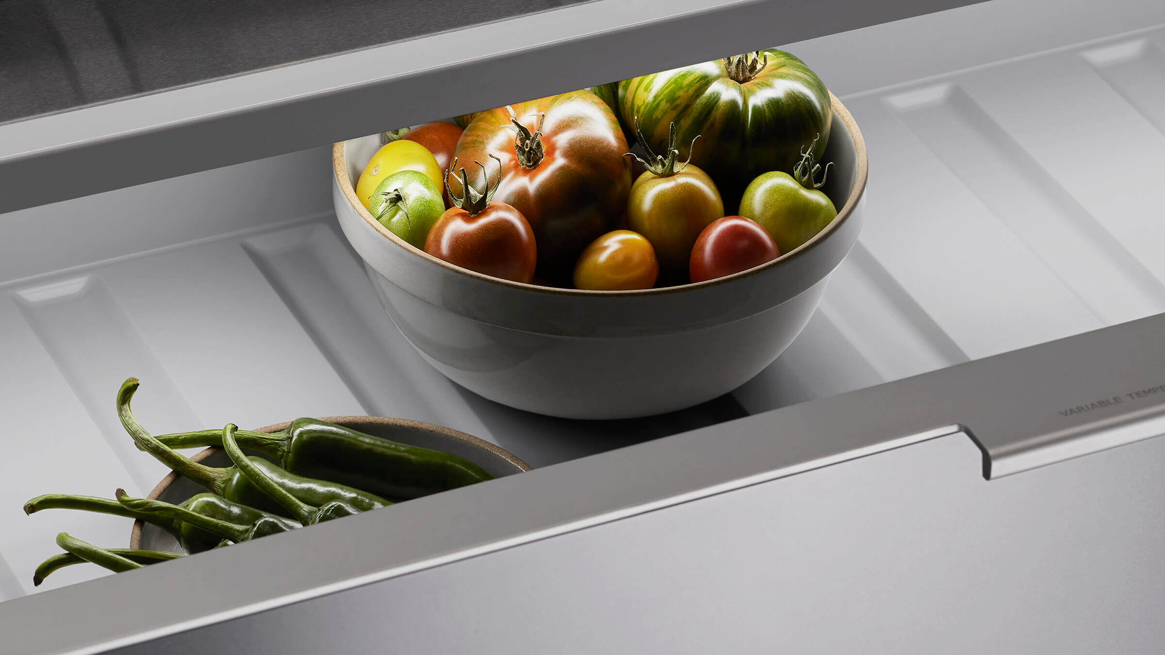 Internal view of a vertical refrigerator showing organized food storage across glass shelves