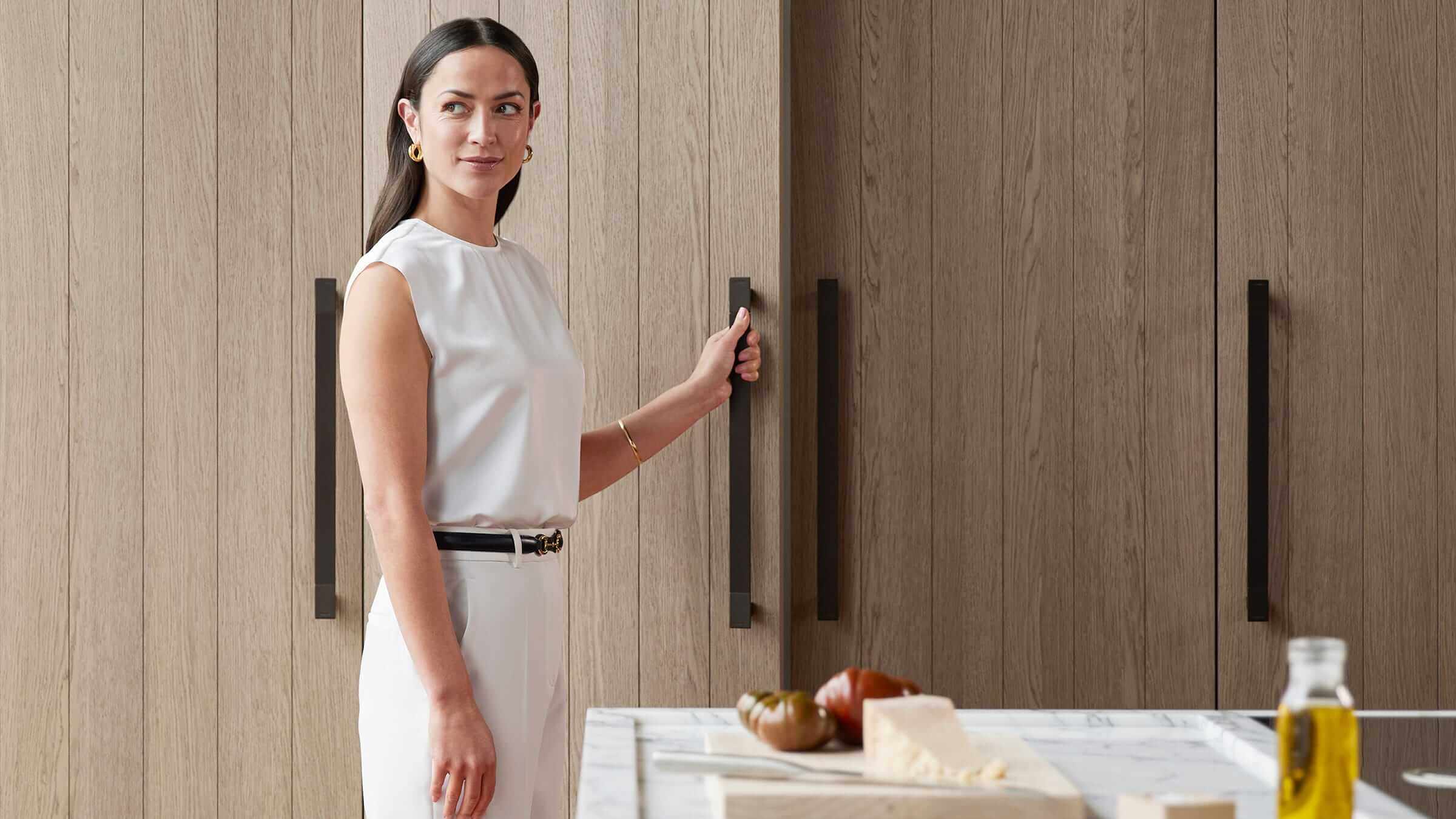 Clean lines of integrated refrigeration columns in an open-plan contemporary kitchen