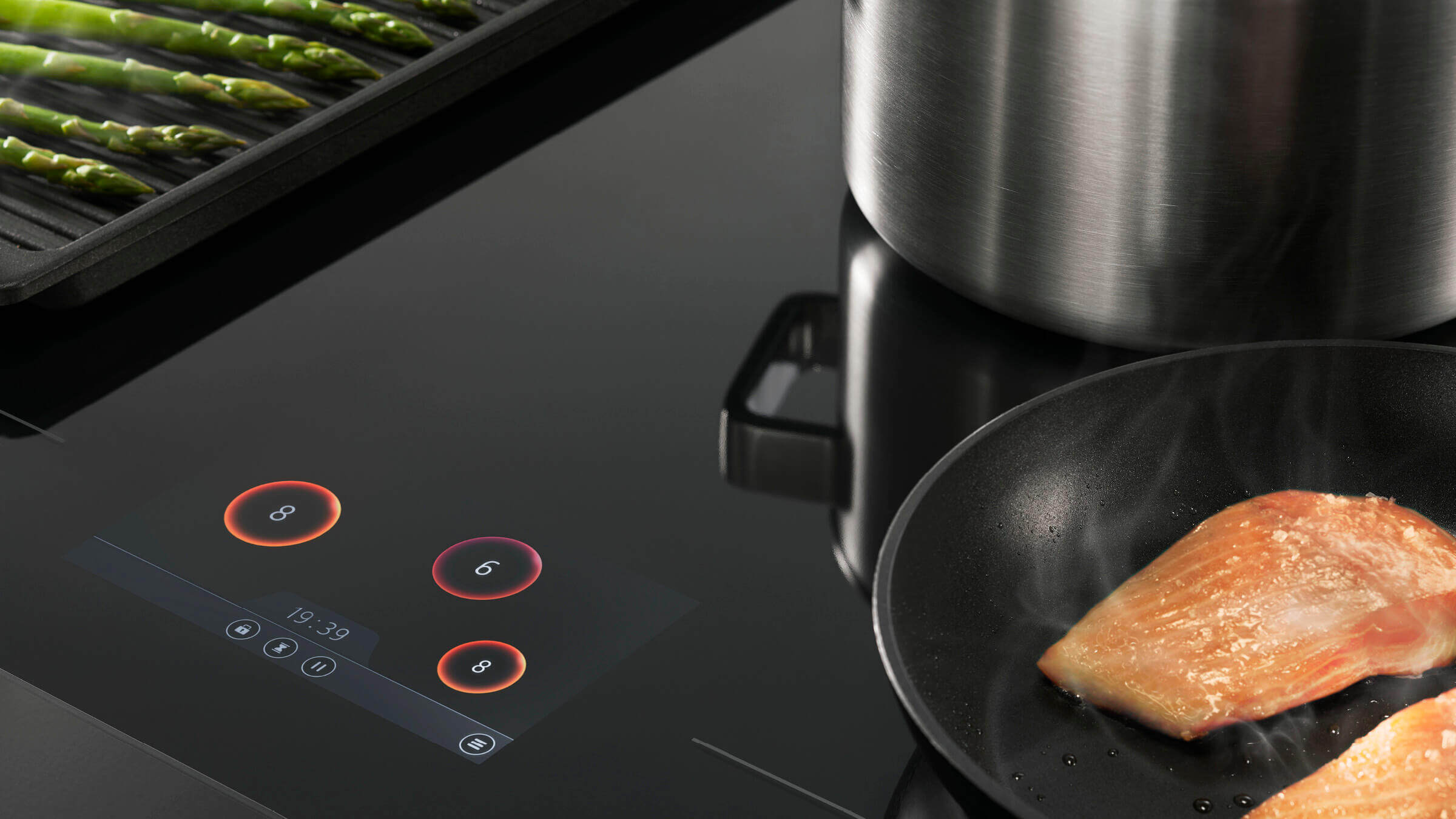 Glass Cooktop showing controls and pan with food 