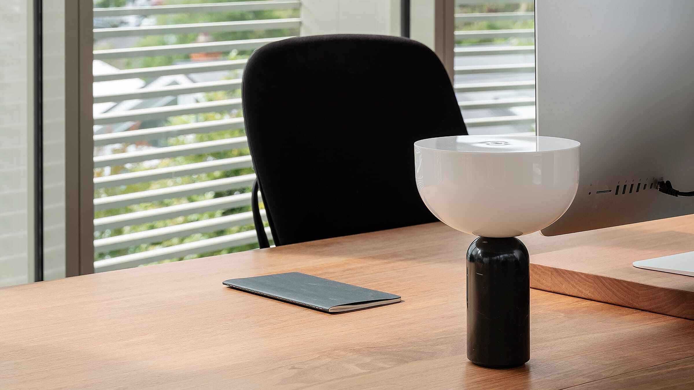 Office desk space with window behind