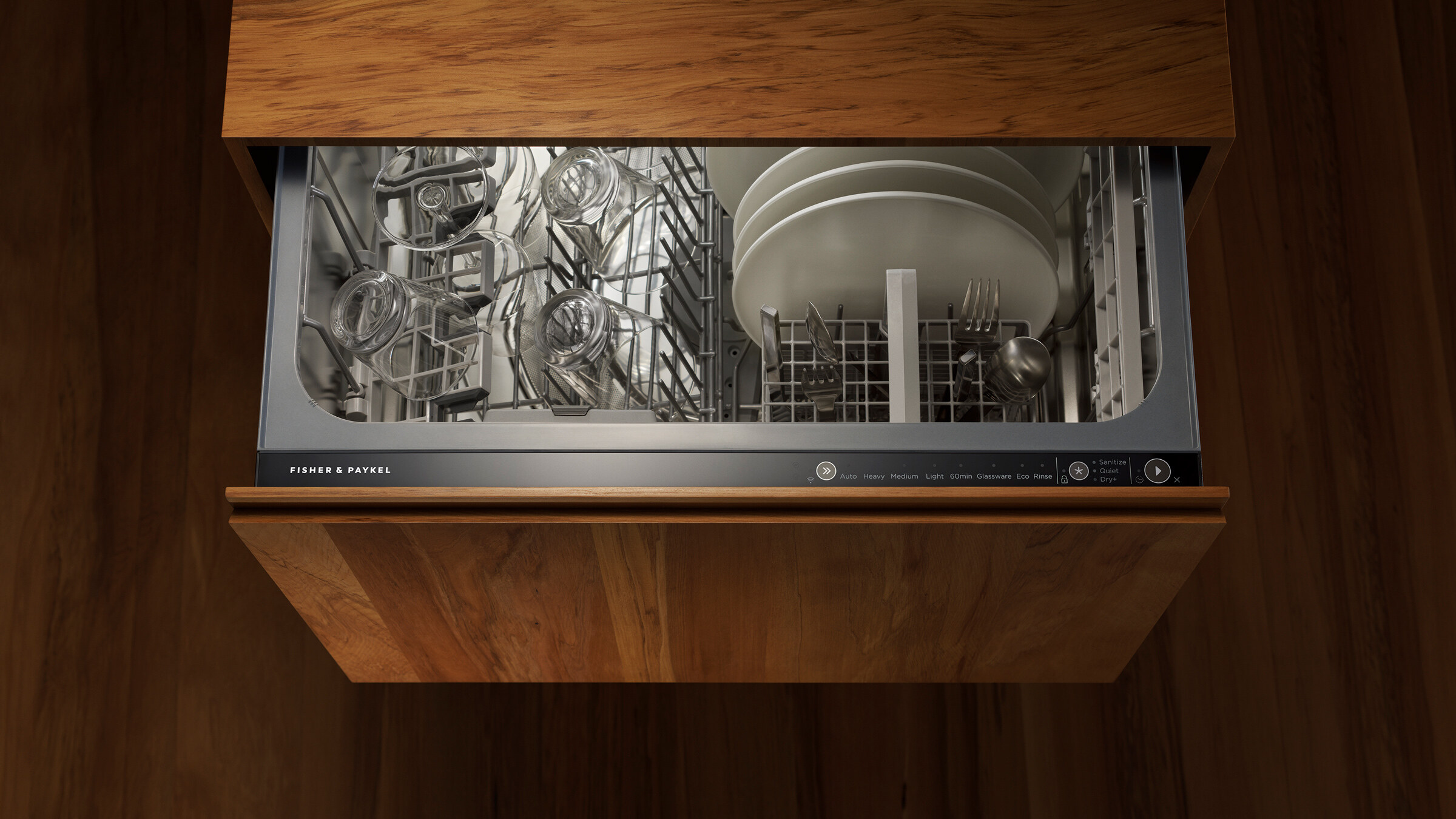 Kitchen with black cabinetry looking through to a black dining table on a backdrop of white floor length curtains.