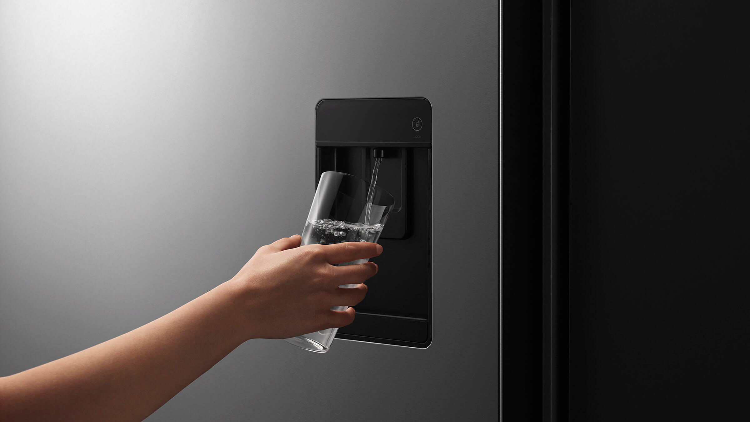 Close-up of a sleek external water dispenser on a contemporary French Door refrigerator