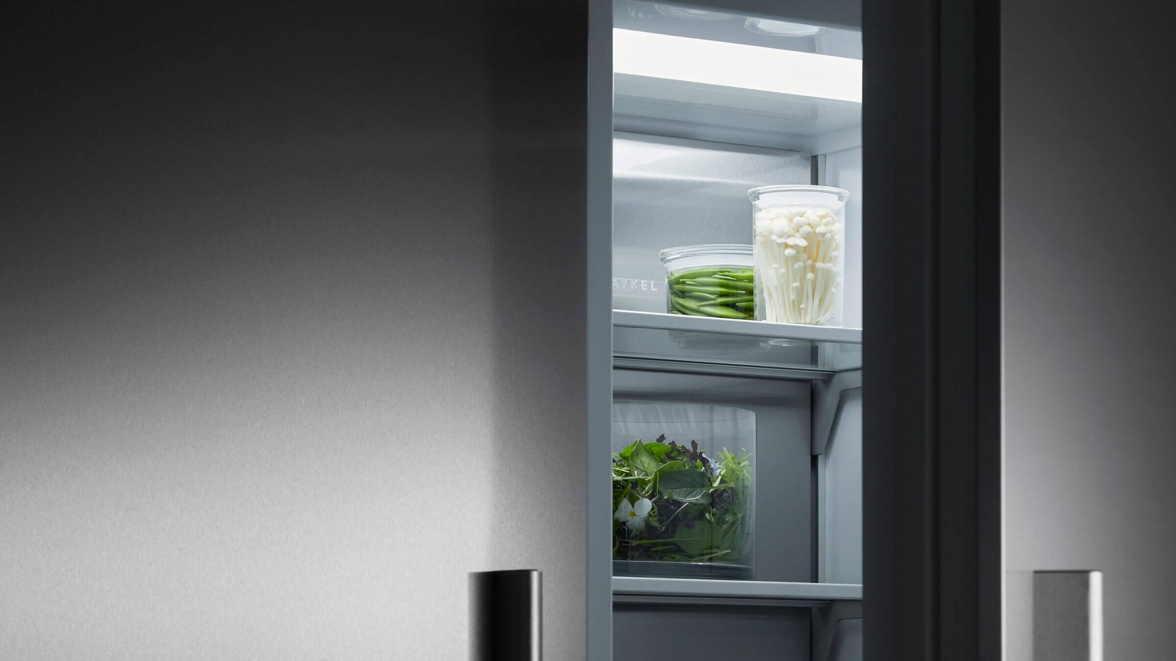 A bright, well-lit interior of a vertical refrigerator showing a full view of stored food