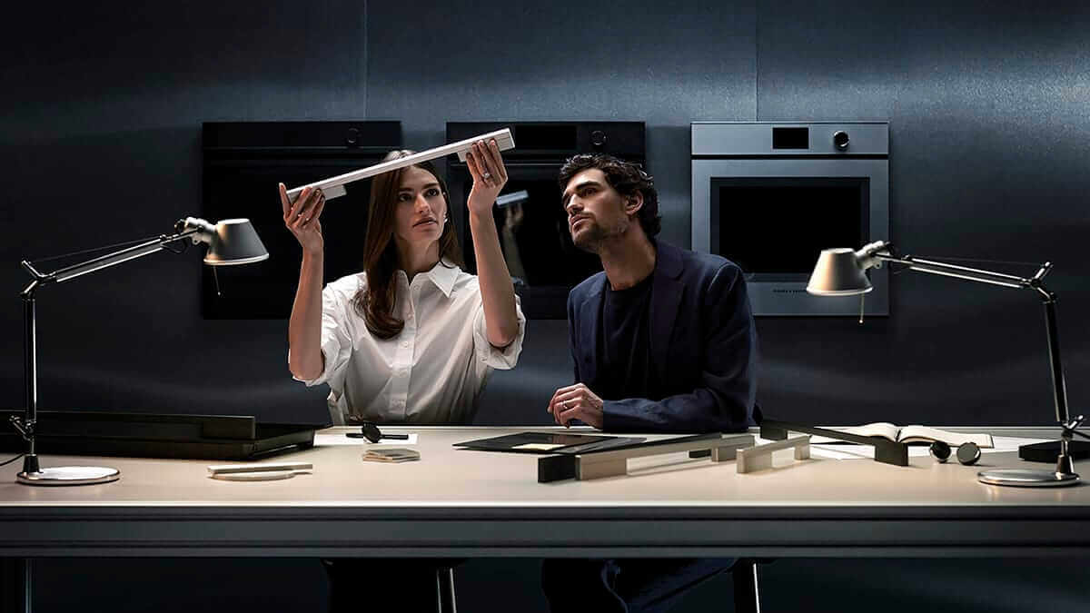 Designers discussing oven door.