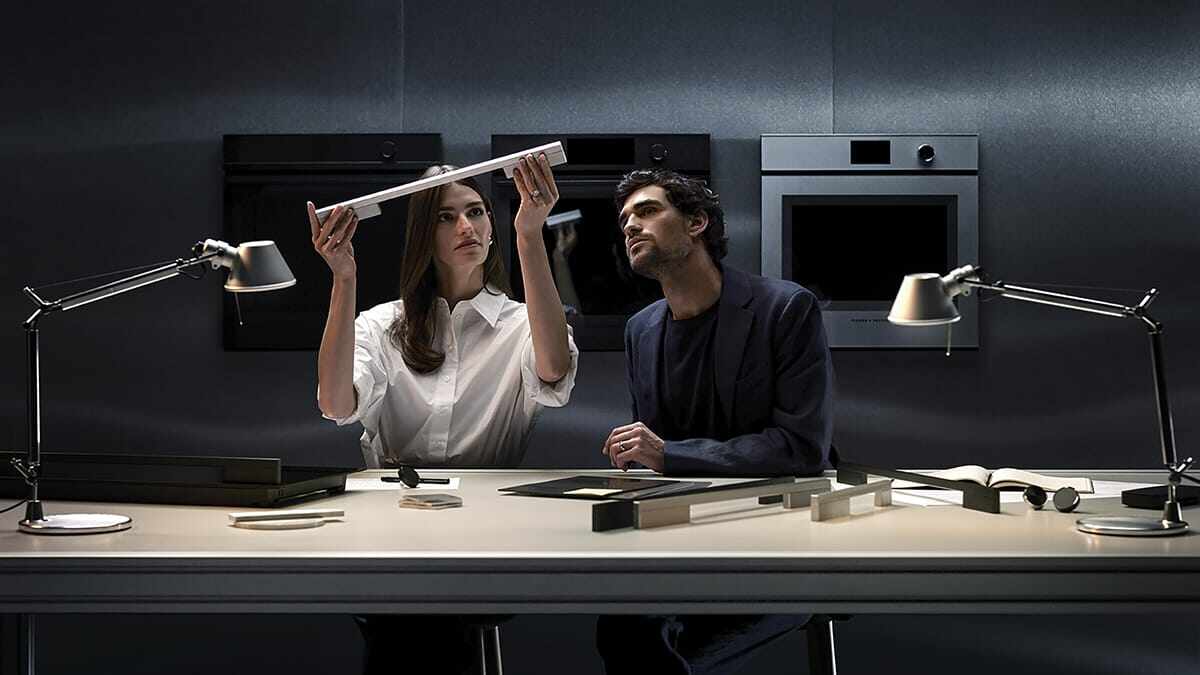Designers discussing oven door.