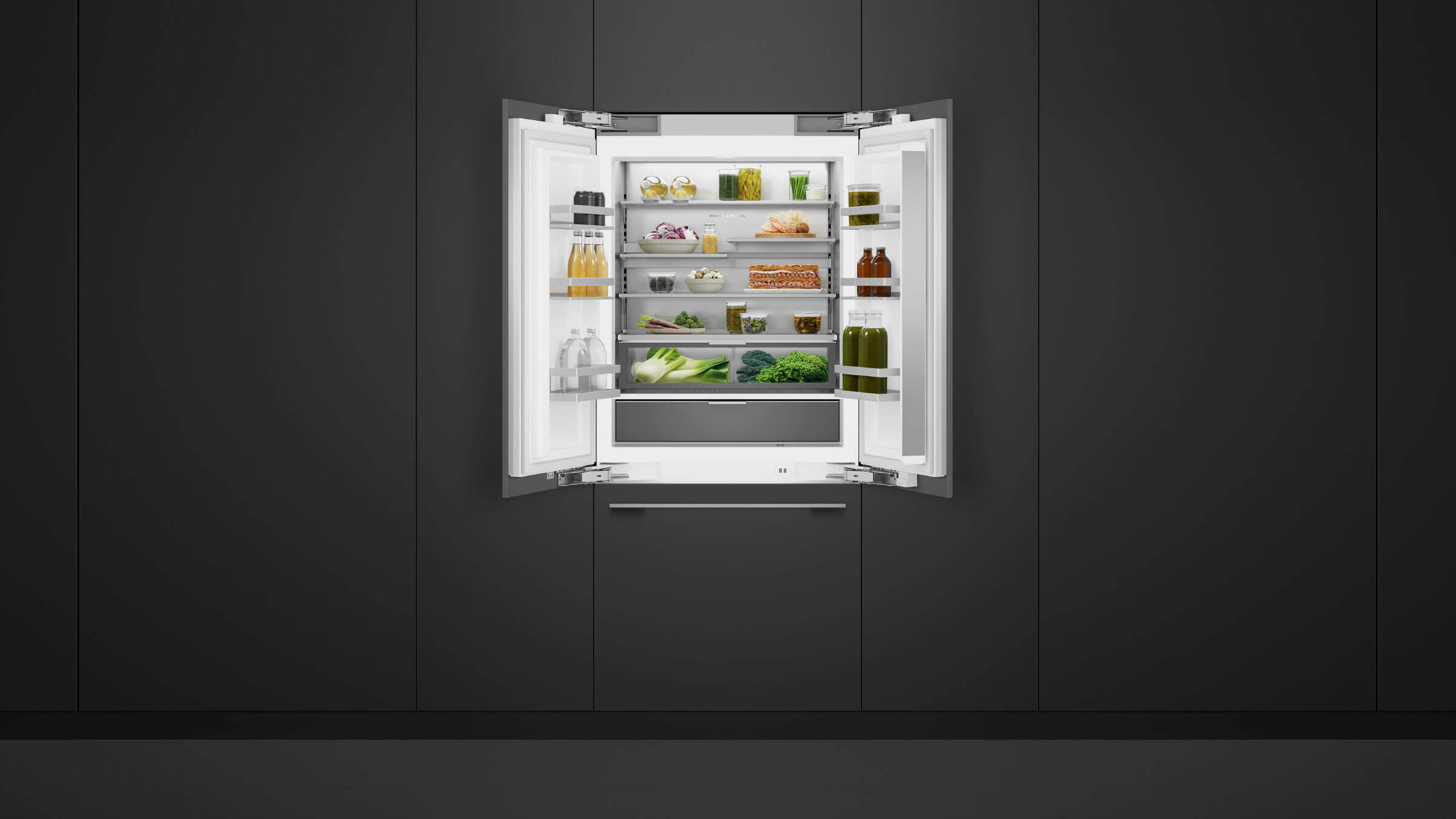 A trio of integrated refrigeration columns installed flush in a dark wood kitchen environment