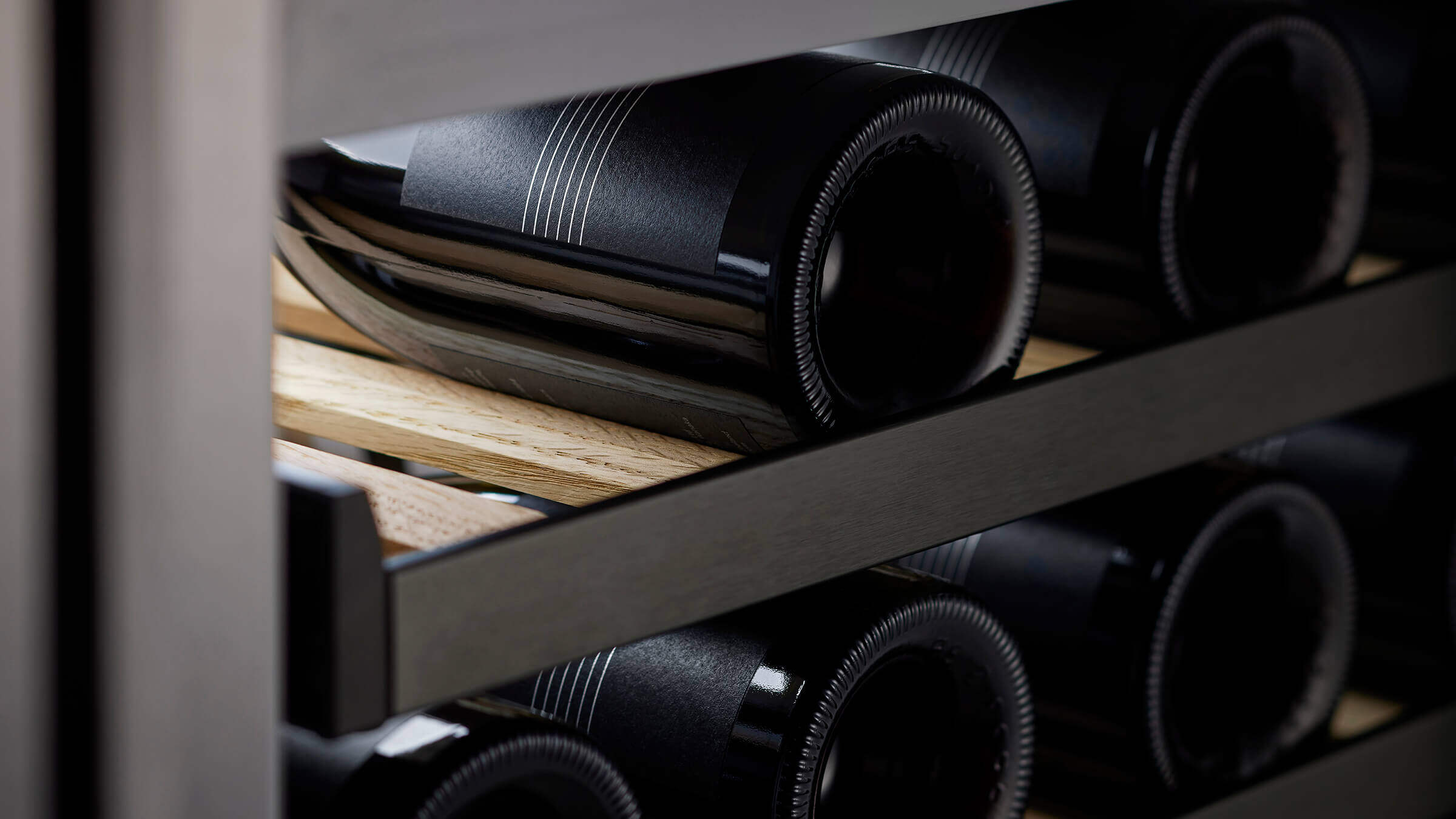 Wine bottles on oak shelves for long-term cellaring