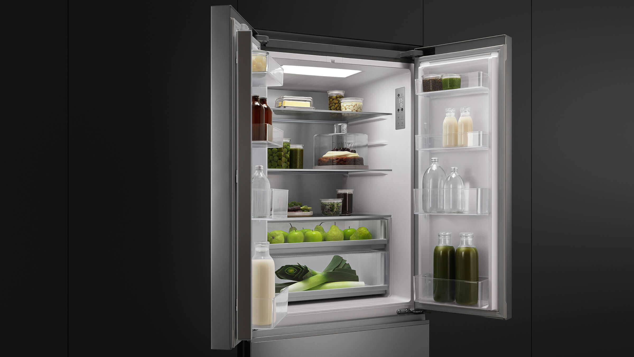 Interior of an open French Door refrigerator showing wide, organized shelving with fresh produce