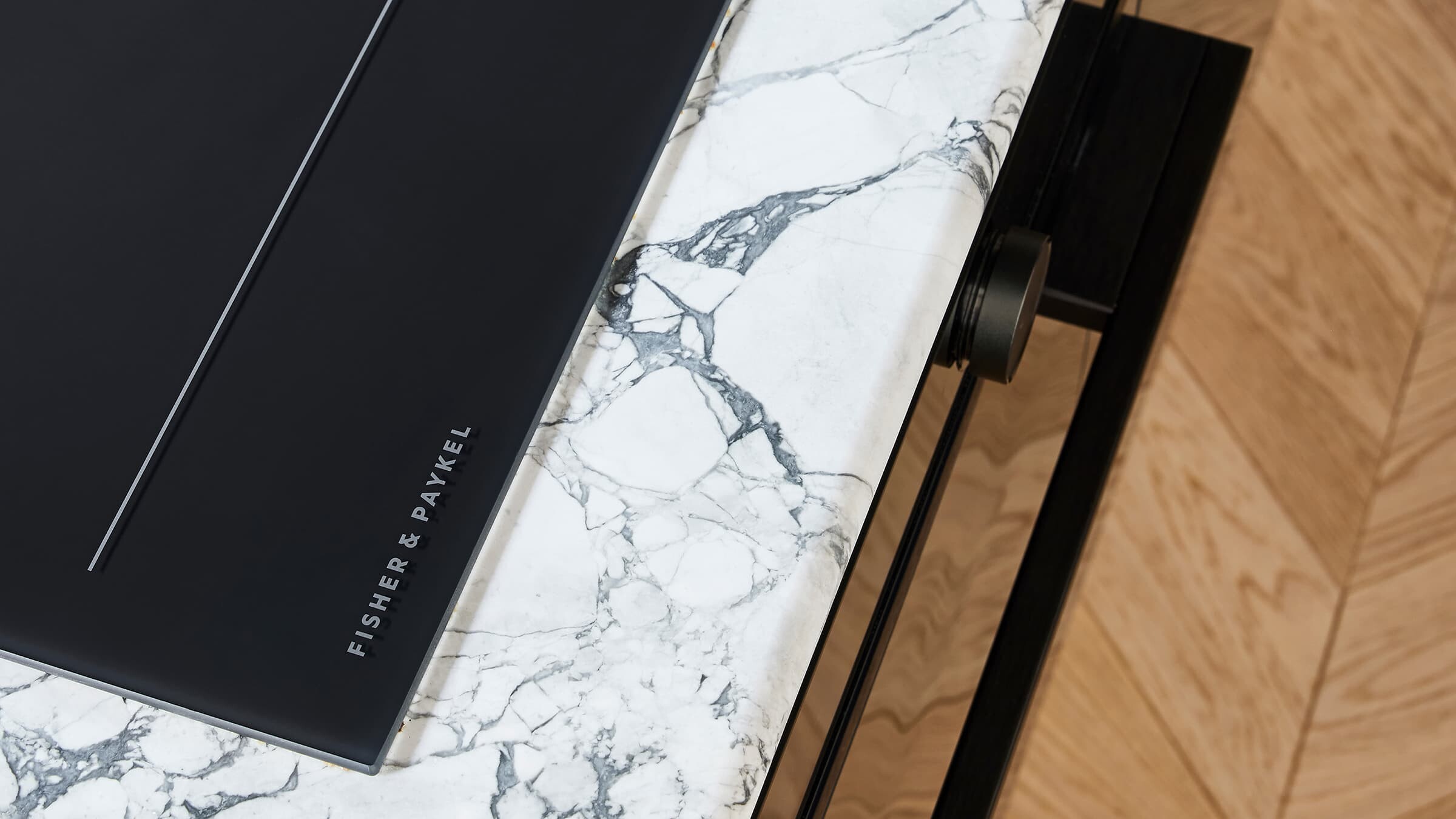 looking from the induction cooktop on a marble surface towards the minimal oven
