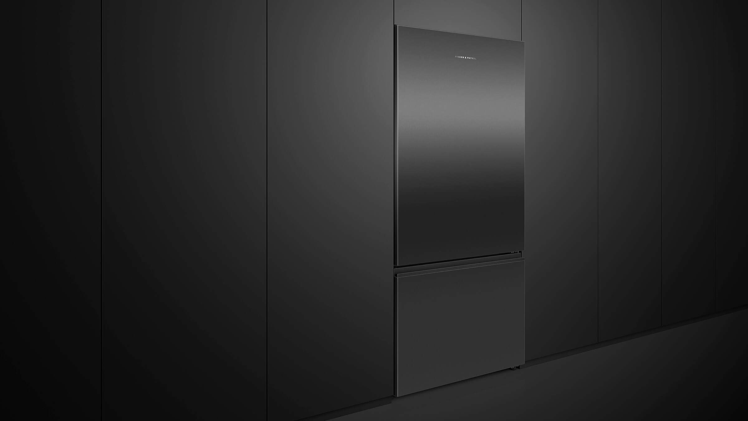 A contemporary black stainless steel refrigerator in a minimalist kitchen